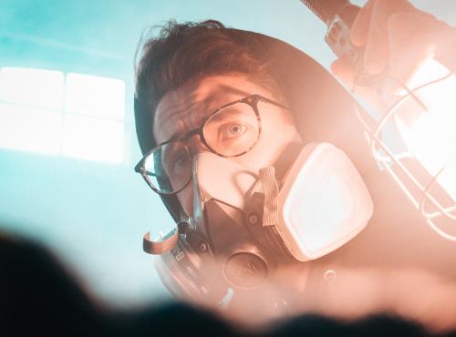 Man in breathing mask holding a light 