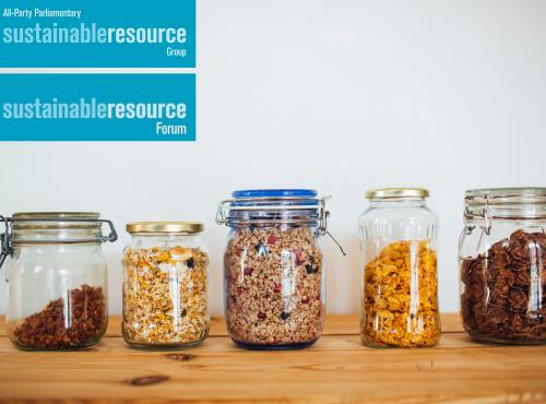 Shelf with line of glass jars containing a variety of dry store food goods