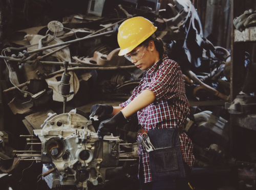 Person with yellow hard hat working in manufacturing