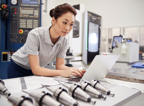 Female engineer working in a on a laptop in a factory or lab