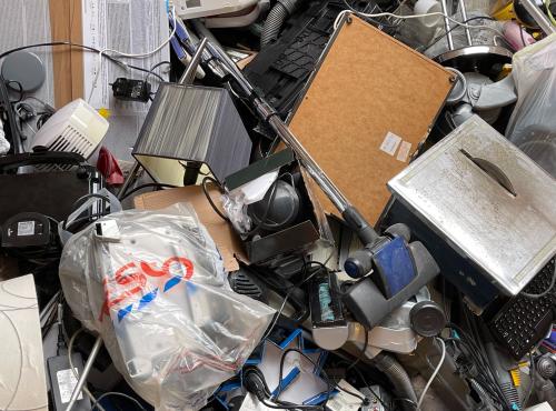 Close-up photograph of a pile of household electricals awaiting recycling