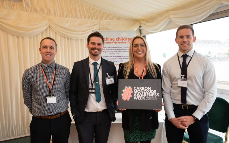 Attendees with sign for Carbon Monoxide Awareness Week