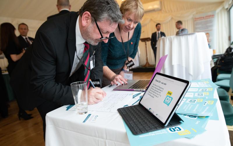 Attendees looking at stall with information on CO awareness