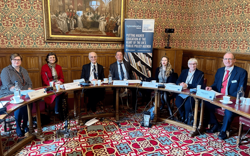 Panellists sitting around horse shoe table