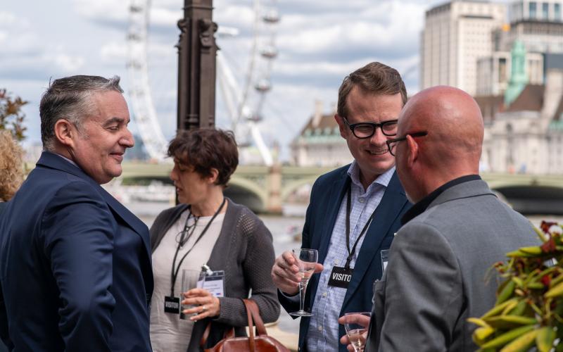 Guests speaking at Parliament terrace overlooking the Thames river