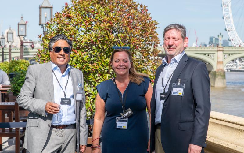 Guests smiling to the camera on the balcony of Westminster Palace