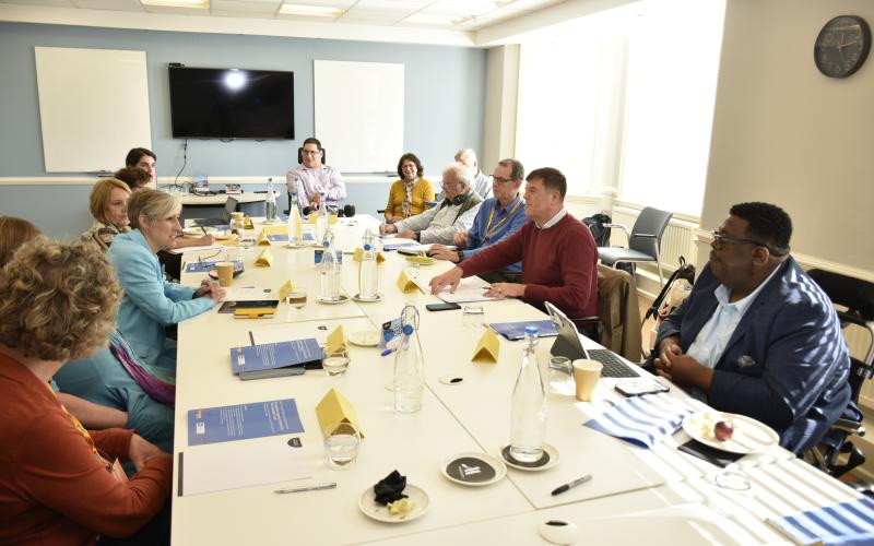 Attendees discussing around the table