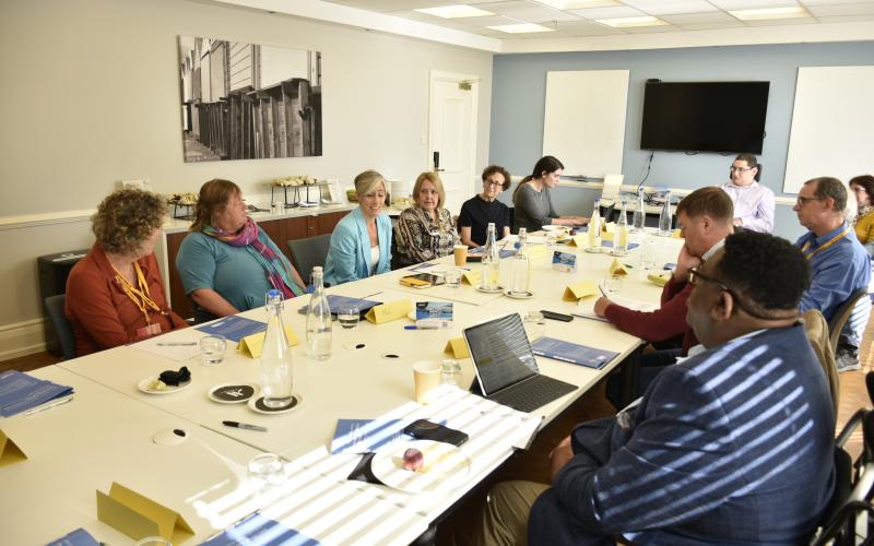 Attendees deep in discussion around the table