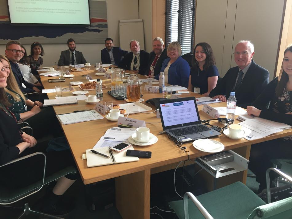 A photograph of the roundtable attendees sitting in a meeting room inside Portcullis House